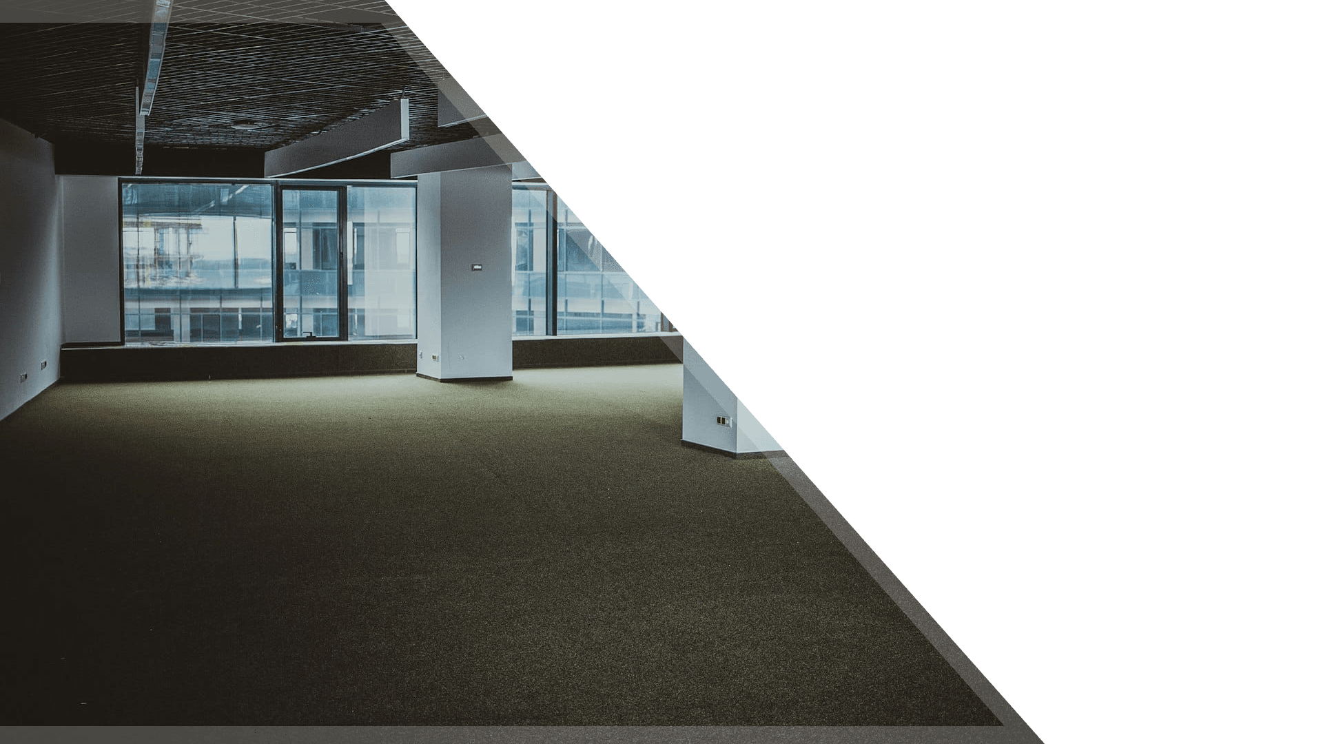 Empty office floor with daylight through large windows
